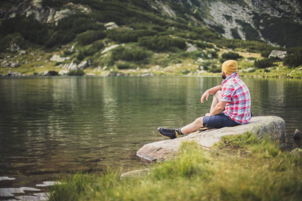 istock Traveler relaxing at the lake in mountains 640168940