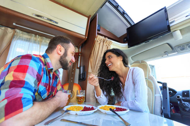 istock Cheerful young couple eating inside of a camper 640170698