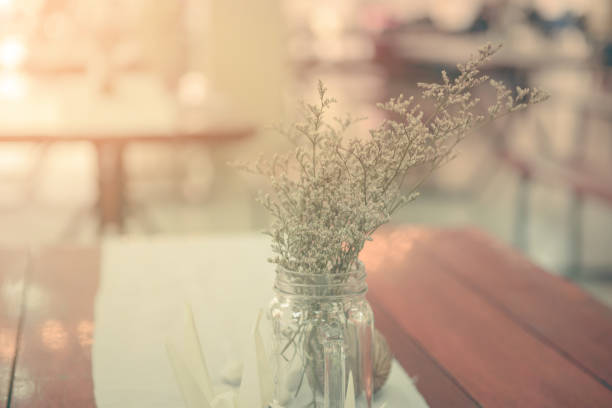 istock Bunch of tiny flower grass have decoration on wooden table 640170874