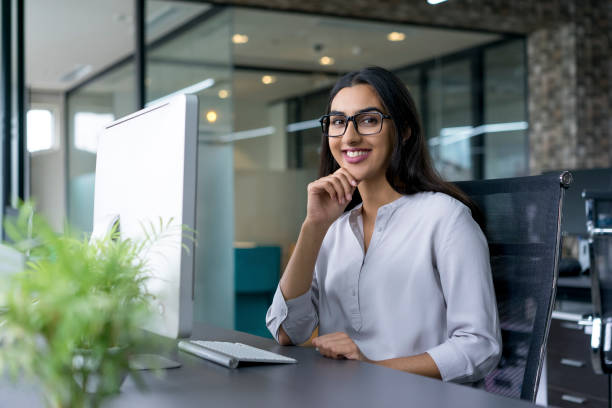 istock Cheerful young businesswoman working in office 640180388