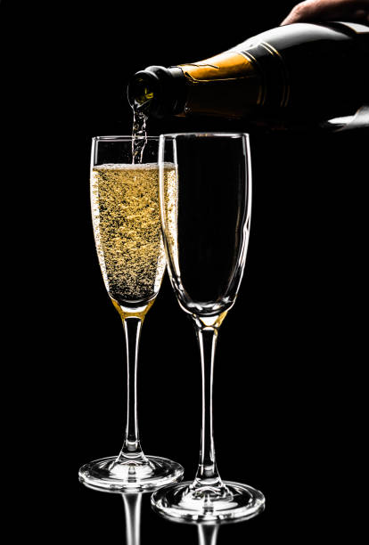 istock mans hand pouring wine from bottle into glass, close up 640180408