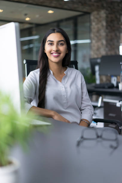 istock Portrait of cheerful female leader at computer 640180508