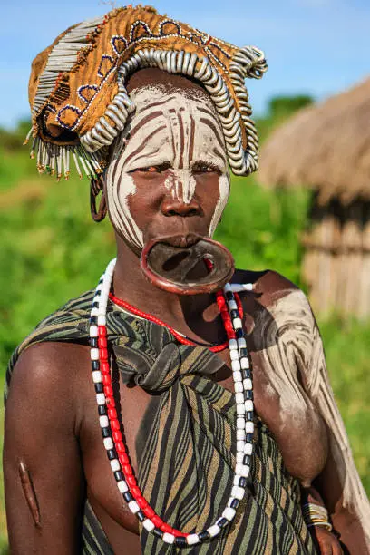 Woman from Mursi tribe with face paint. Mursi tribe are probably the last groups in Africa amongst whom it is still the norm for women to wear large pottery or wooden discs or ‘plates’ in their lower lips.http://bhphoto.pl/IS/ethiopia_380.jpg