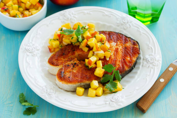 istock Slice the fish grilled with peach salsa. 640182438