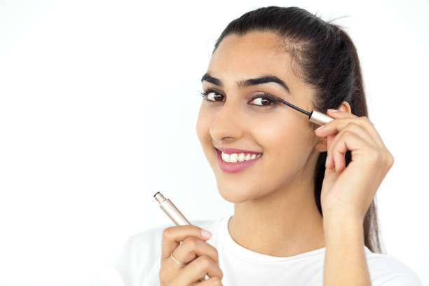 istock Smiling Beautiful Indian Lady Applying Mascara 640183536
