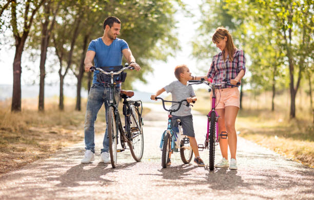 istock Smiling family with bicycles spending day at the park. 640184696