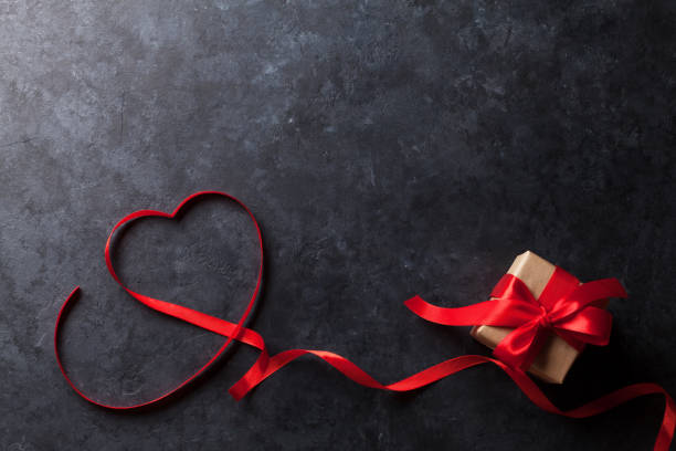 istock Valentines day. Heart shaped red ribbon and gift 640185182