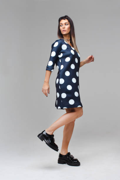istock Model in blue dress with polka dots making steps 640185526