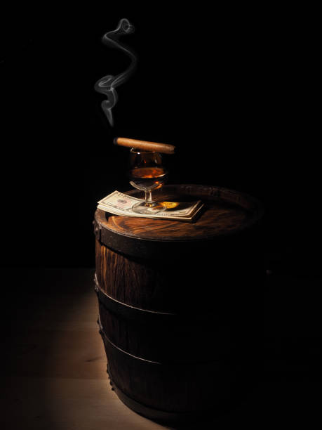 istock Cognac ,Cigar and dollars on old oak barrel 640185850