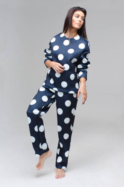 istock Barefoot model in blue polka dots pajamas staying 640186396