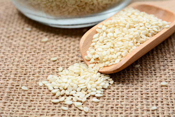 istock White sesame seeds on wooden spoon 640187188