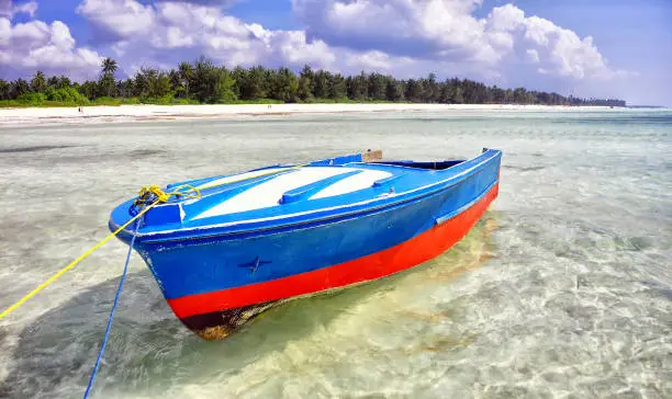 A fisherman's boat floats in the shallows off Zanzibar Island.