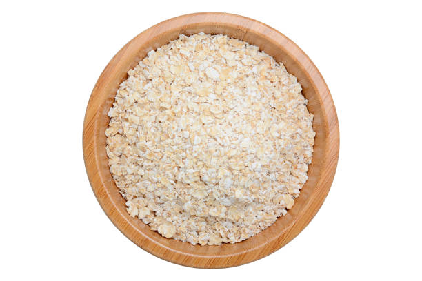 istock oat flakes in wooden bowl isolated on white 640188124