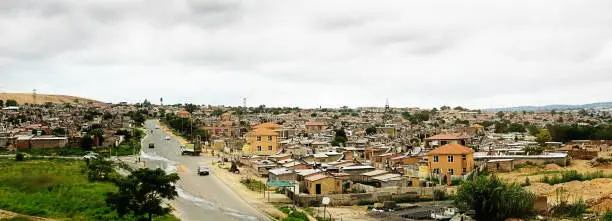 Distant, panoramic view of Alexandra township in Marlboro, North of Johannesburg, South Africa. Copy space on the cloudy sky.