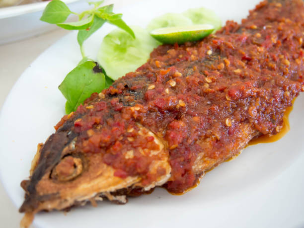 istock Thai Tradition Food, deep-fried fish topped with fresh herbs and 640188416