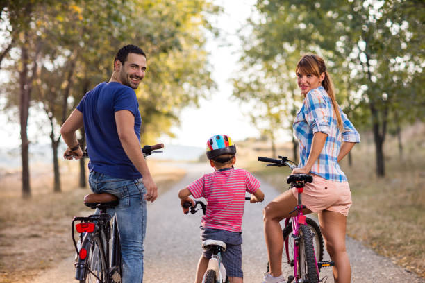 istock Smiling parents with son enjoying on bicycles in nature. 640188632