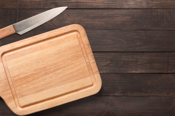 istock Knife and cutting board on the wooden background. 640190354