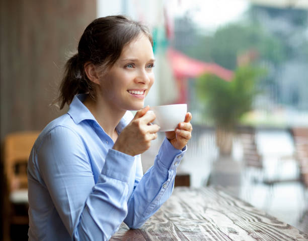 istock Smiling businesswoman drinking coffee in cafe 640191164