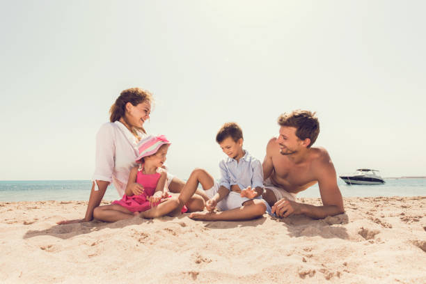 istock Smiling family spending a summer day on the beach. 640192076