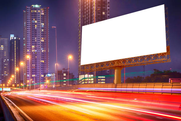 istock blank billboard on light trails, night street and urban 640192800