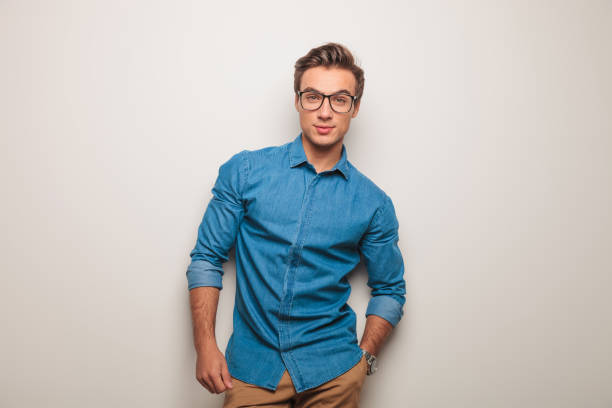 istock young casual man with glasses standing in studio 640194858