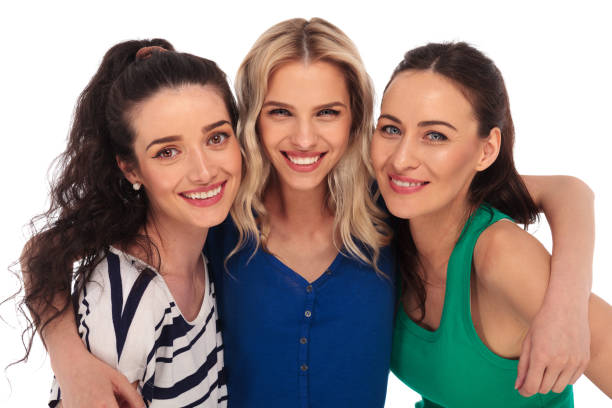 istock Three young women holding each other close and smile 640195072