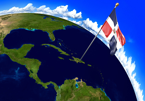 3D render of the national flag of Dominican Republic over the geographic location of the country on a world map. Parts of this image furnished by NASA.