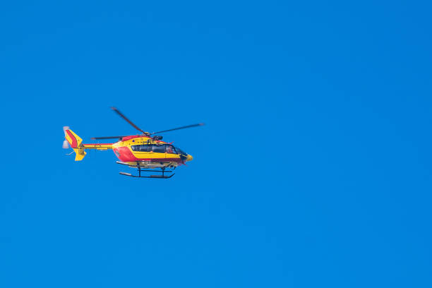 istock Red and yellow rescue helicopter moving in blue sky 640195272