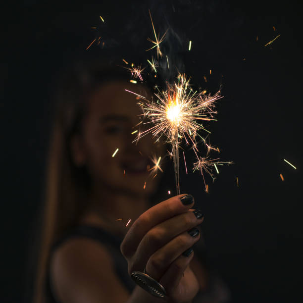 istock Beautiful and elegant young woman celebrating with a sprinkle in 640197580
