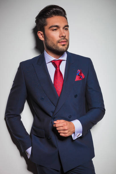 istock portrait of a gentleman leaning against grey wall 640199378