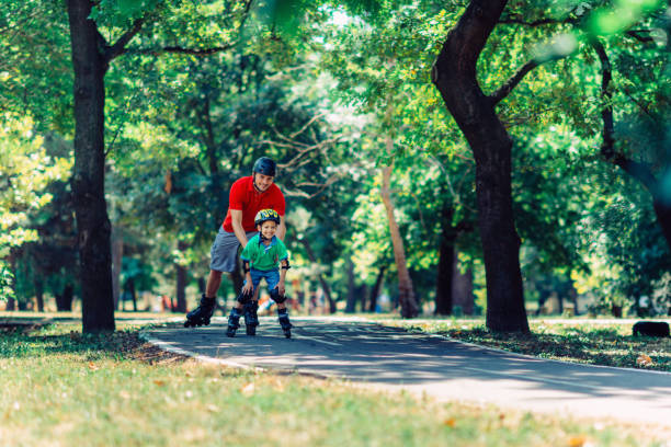 istock Little boy learning roller skating in the park 640199510