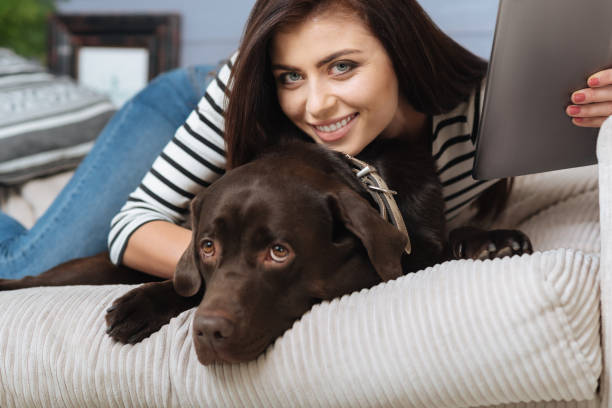 istock Positive cute woman entertaining herself and her pet 640200036