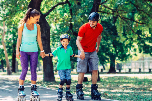 Family roller skating Family roller skating elbow pad stock pictures, royalty-free photos & images