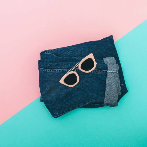 istock pink sunglasses on jeans 640200896