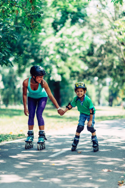 istock Mother and son roller skating in park 640200916