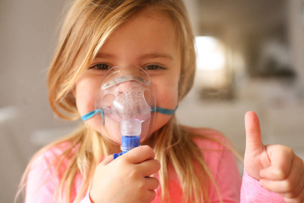 istock Little girl using inhaler. 640201808