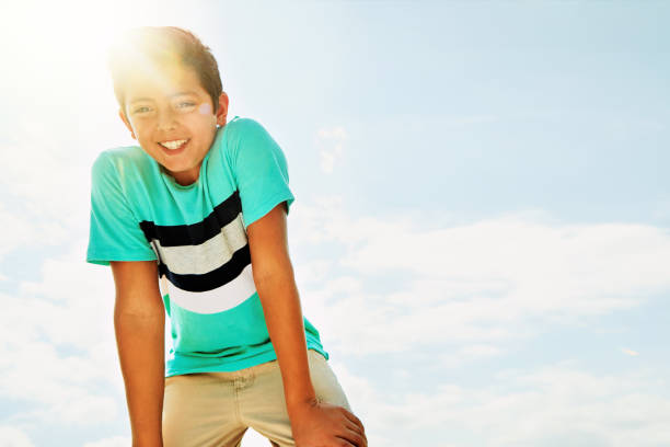 Portrait of an adorable little boy sitting on stairs on a summer's day outdoors