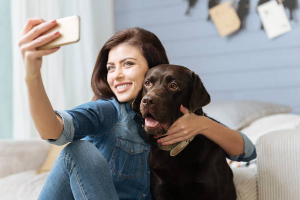 Happy stunning woman using her smartphone