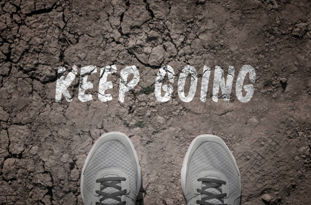 istock Sneakers on dry land with the text: Keep going 640204568