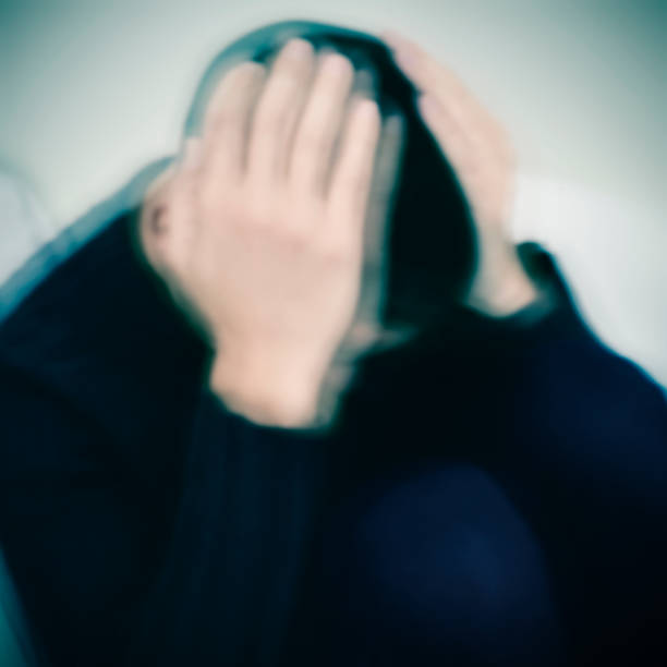 istock man curled up with his hands in his head 640204630