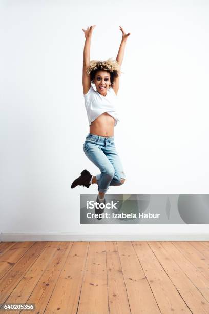 Happy Afro American Young Woman Jumping Stock Photo - Download Image Now - Jumping, Women, One Woman Only