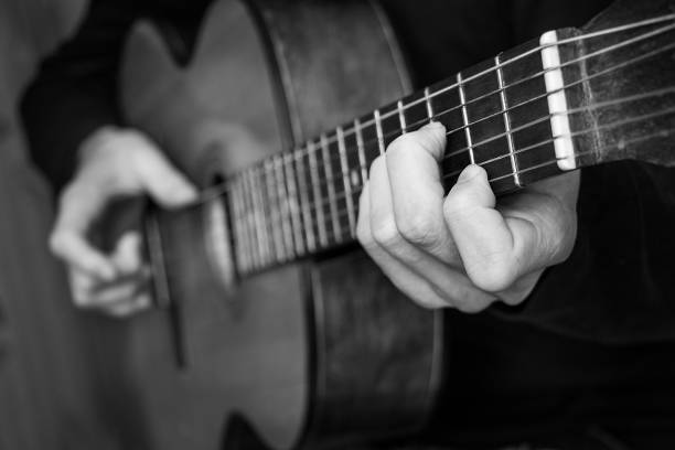 istock Man playing classical guitar. Black and white photo. 640205424