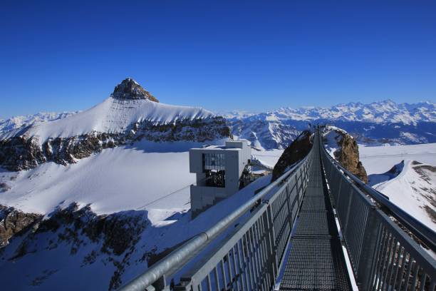 mount oldenhorn and suspension bridge - bernese oberland gstaad winter snow imagens e fotografias de stock