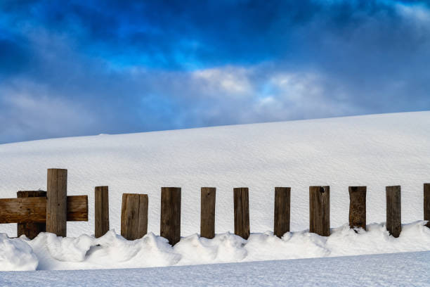istock Snow-covered wooden fence 640207420