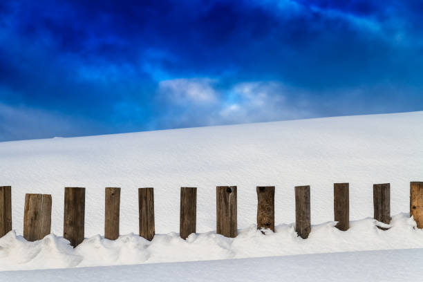 istock Snow-covered wooden fence 640207498