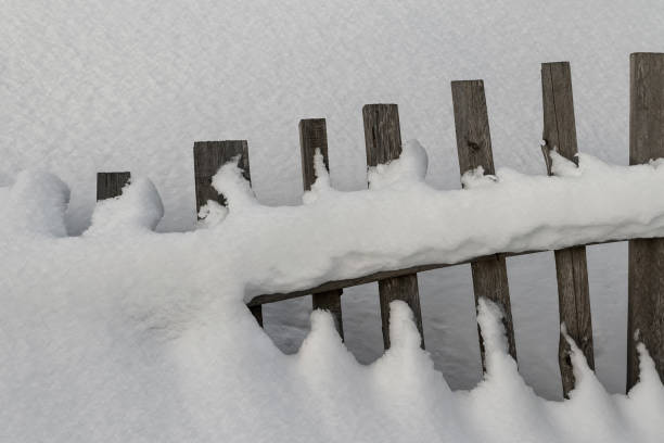 istock Snow-covered wooden fence 640207642