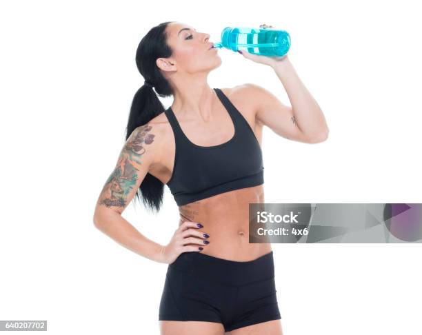 sexy woman in sport bra and panties holding sport bottle and