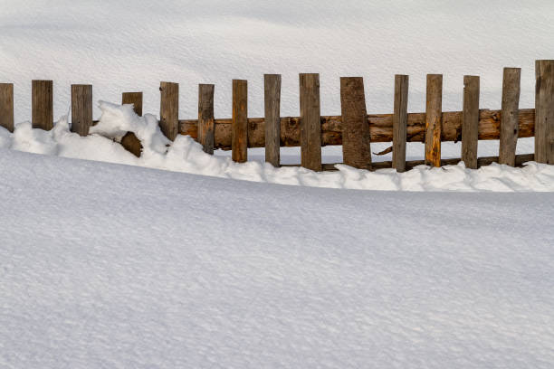 istock Snow-covered wooden fence 640207774