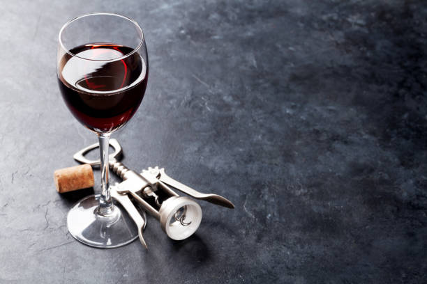 istock Red wine glass and corkscrew 640212160
