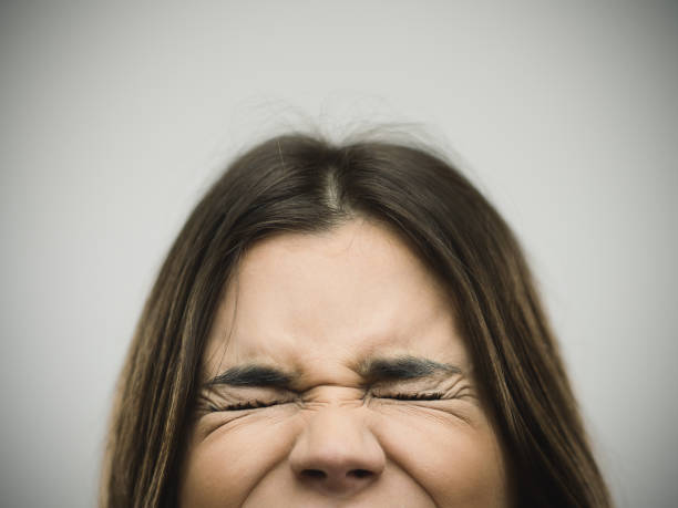 istock Angry young woman clenching eyes 640215328